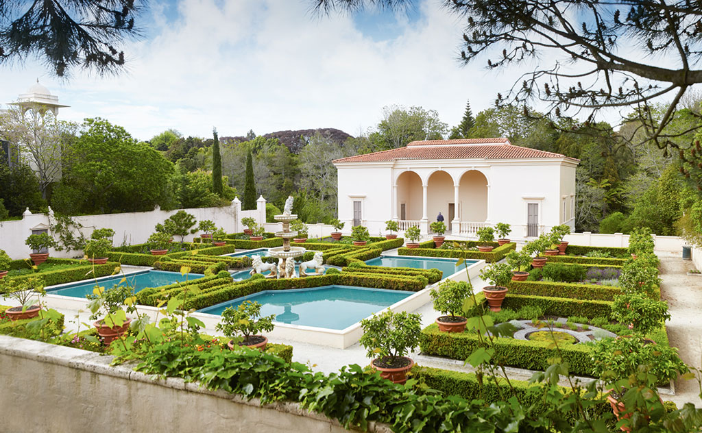 An ornate and immaculately kept garden with box hedges and white walls in the Italian Renaissance Garden at Hamilton Gardens, Waikato, New Zealand